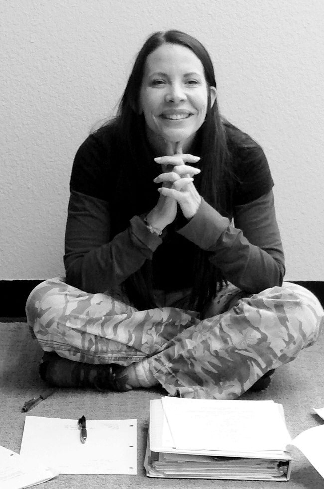 Annie Biggs seated on the floor with pages and a script