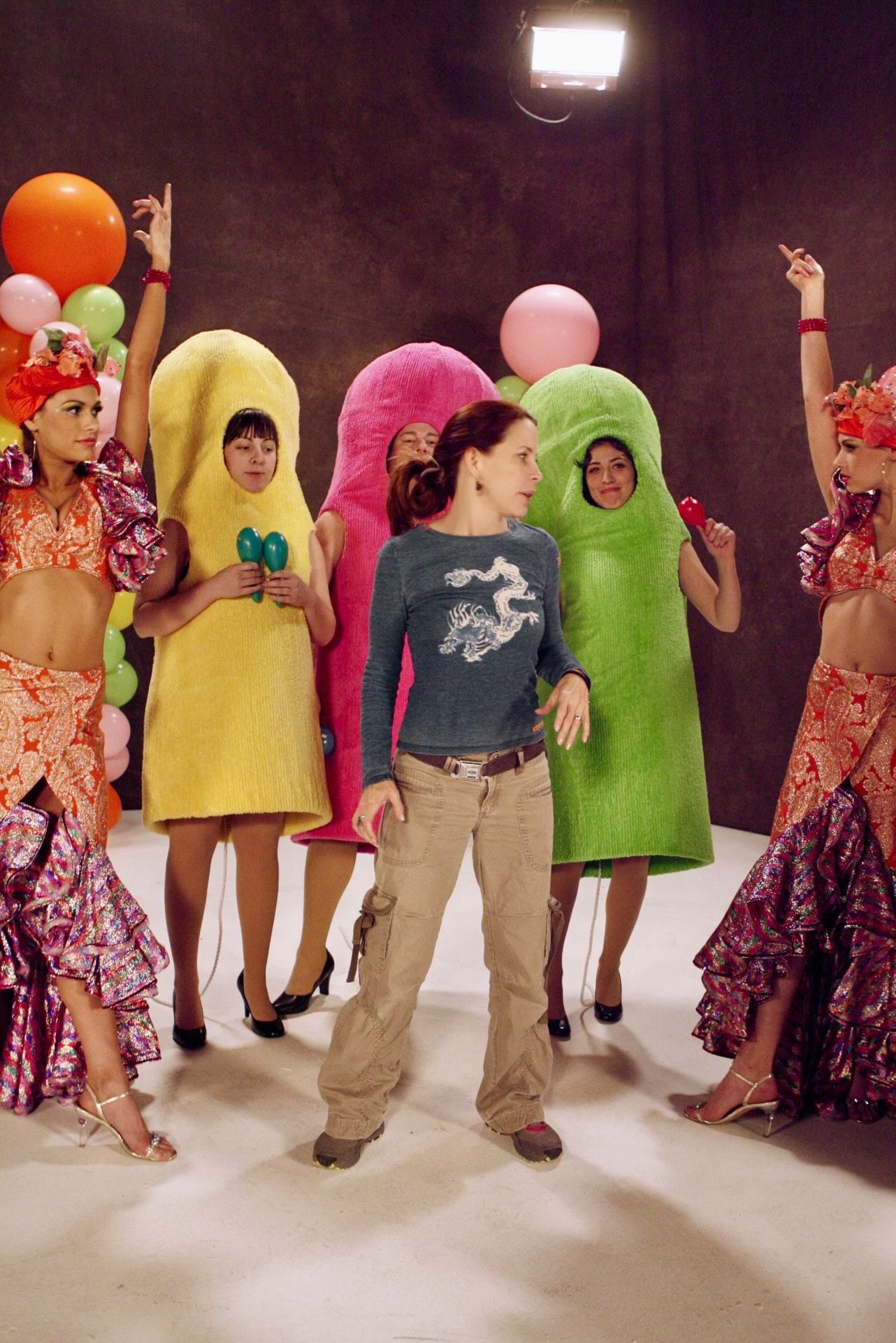 Annie Biggs directing a production with costumed performers on set